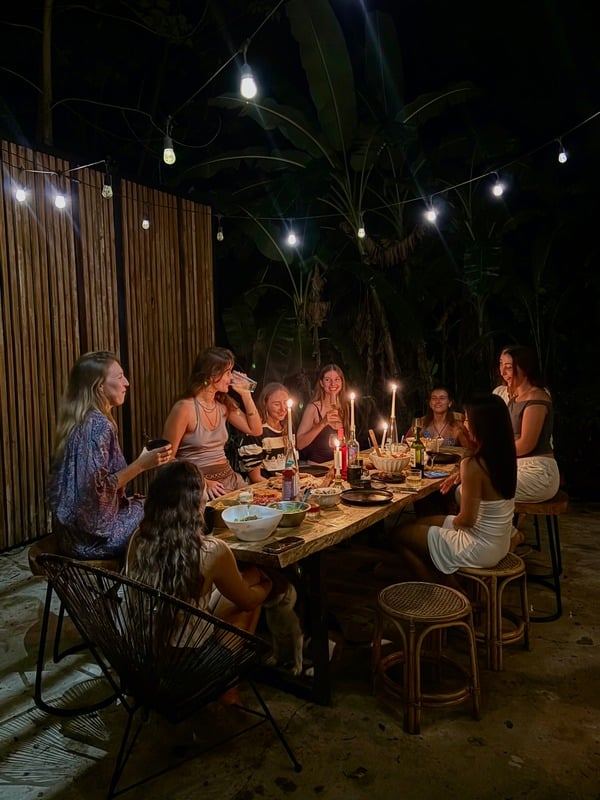 Long table dinner under string lights at night